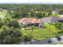 Backyard with screened patio overlooking a canal at 2197 Nita Ter, North Port, FL 34286