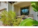 Inviting front porch with seating and lush landscaping at 24113 Spartina Dr, Venice, FL 34293