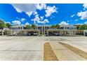 Community parking area with covered carport and guest parking at 872 Saranac Lake Dr # 202, Venice, FL 34292
