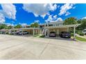 Community parking area with covered spaces and ample room for residents at 872 Saranac Lake Dr # 202, Venice, FL 34292