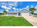 Single story home with light blue exterior, tile roof and landscaping at 5076 Kingsley Rd, North Port, FL 34287