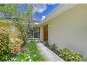 Pathway to the front entrance with lush green landscaping at 338 Pembroke Dr # 208, Venice, FL 34293