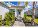 Welcoming entryway with brick walkway and lush landscaping at 12760 Brookgreen St, Venice, FL 34293