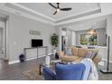 Open living room with a tan couch and a view to the kitchen at 12760 Brookgreen St, Venice, FL 34293