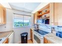 Kitchen with light wood cabinets and a view at 708 Tamiami S Trl # 319, Venice, FL 34285