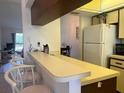 Kitchen boasts a breakfast bar and ample counter space at 929 Capri Isles Blvd # 22, Venice, FL 34292