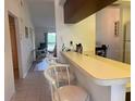 Kitchen with breakfast bar and view into living area at 929 Capri Isles Blvd # 22, Venice, FL 34292