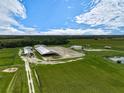 Aerial view of equestrian property with arenas and barns at 27000 Harrison Rd, Sidell, FL 34266