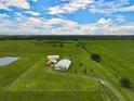 Aerial view of a rural property featuring a home and large acreage at 27000 Harrison Rd, Sidell, FL 34266