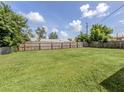 Spacious backyard with wooden fence and lush green grass at 1020 Roberta St, Venice, FL 34285