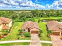 Single-story home with tile roof and landscaped yard at 12261 Canavese Ln, Venice, FL 34293
