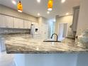 Modern kitchen with granite countertops and white cabinets at 3610 Woodbridge Ave, North Port, FL 34287