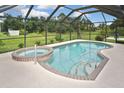 Relaxing screened-in pool and spa area with ample patio space at 4241 Chamrade Rd, North Port, FL 34288