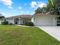 One-story home with a two-car garage and neatly landscaped yard at 4751 Alibi Ter, North Port, FL 34286