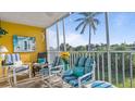 Relaxing screened porch with comfy seating and water views at 1401 S Mccall Rd # 107B, Englewood, FL 34223