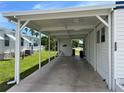 Covered carport with concrete flooring providing shade and parking at 200 Roma Rd, Venice, FL 34285