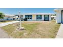 House exterior showcasing a carport and well-maintained lawn at 475 Circlewood Dr # O18, Venice, FL 34293