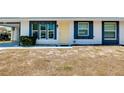 Front view of the house, highlighting its yellow door and landscaping at 475 Circlewood Dr # O18, Venice, FL 34293