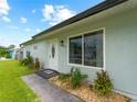 Teal house exterior with white door and landscaping at 3704 Nekoosa St, North Port, FL 34287