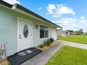 Front door view of a teal house with walkway at 3704 Nekoosa St, North Port, FL 34287