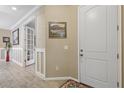 Bright entryway with tile flooring, white door and view into another room at 12000 Tapestry Ln, Venice, FL 34293