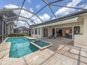 Screened pool and spa with extended patio and view to the interior at 117 Savona Way, North Venice, FL 34275