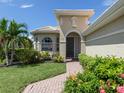 Welcoming entryway with brick walkway, landscaping, and arched entry at 117 Savona Way, North Venice, FL 34275