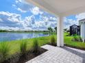 Covered patio overlooking a peaceful lake at 18260 Vizcaya Ct, Venice, FL 34293