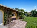 Front entryway with brick pavers and mature foliage at 424 Baycrest Dr, Venice, FL 34285
