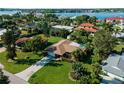 Aerial view of a single-Gathering home with a pool, lush landscaping, and a waterfront location at 424 Baycrest Dr, Venice, FL 34285