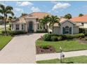 Luxury house with tile roof, landscaping, and a large driveway at 145 Montelluna Dr, North Venice, FL 34275