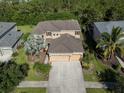 Two-story house with a three-car garage and landscaping at 2585 Hobblebrush Dr, North Port, FL 34289