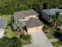 Two-story house with a three-car garage and landscaping at 2585 Hobblebrush Dr, North Port, FL 34289