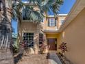 Two-story house with palm trees and walkway at 2585 Hobblebrush Dr, North Port, FL 34289