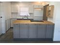 Updated kitchen featuring gray cabinets, butcher block countertops, and stainless steel appliances at 268 Shamrock Blvd, Venice, FL 34293