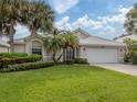 Single-story home with a landscaped lawn and attached garage at 1522 Belfry Dr, Venice, FL 34292