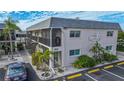 Two-story building with multiple units, balconies, and parking at 612 Guild Dr # 18, Venice, FL 34285