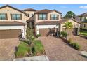 Community of two-story townhomes with tile roofs and lush landscaping at 12460 Ghiberti Cir # 202, Venice, FL 34293
