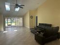 Bright living room with high ceilings, tile flooring, and access to the outdoor pool area at 217 Carriage House Ln # 217, Nokomis, FL 34275