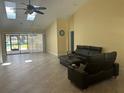 Bright living room with high ceilings, tile flooring, and a modern furniture set at 217 Carriage House Ln # 217, Nokomis, FL 34275