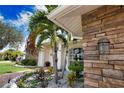 Landscaped entryway with stone accents and palm trees at 5280 E Sunnydale Cir, Sarasota, FL 34233