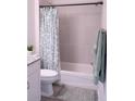 Updated bathroom with a tub shower combination, granite vanity, and neutral color palette at 17501 Belle Eden Way, Nokomis, FL 34275
