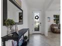 Bright entryway with a black console table, mirror, and wreath at 19304 Bluff Dr, Venice, FL 34292