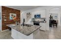 Modern kitchen with white cabinets, granite counters, and stainless steel appliances at 19304 Bluff Dr, Venice, FL 34292