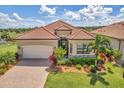 Single-story home with tile roof and landscaped yard at 25159 Spartina Dr, Venice, FL 34293