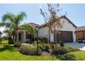 Single-story home with brown garage door and landscaped yard at 232 Carlino Dr, Nokomis, FL 34275