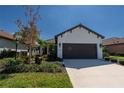 Single-story home with brown garage door and landscaped yard at 232 Carlino Dr, Nokomis, FL 34275