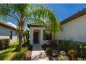 Single-story home with brown door and lush landscaping at 232 Carlino Dr, Nokomis, FL 34275