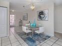 Elegant dining area with glass table and chairs at 1403 Gondola Park Dr # 1403Bd, Venice, FL 34292