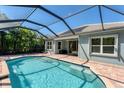 Inviting screened-in pool with paver deck, perfect for relaxation at 12273 Stuart Dr, Venice, FL 34293